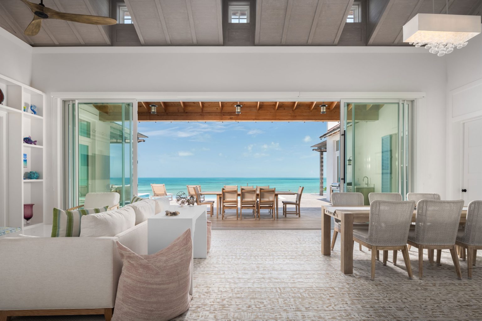 66a26e2ef11040e89dc773e4_09-ambergris-cay-puesta-del-sol-villa-living-dining-3000px