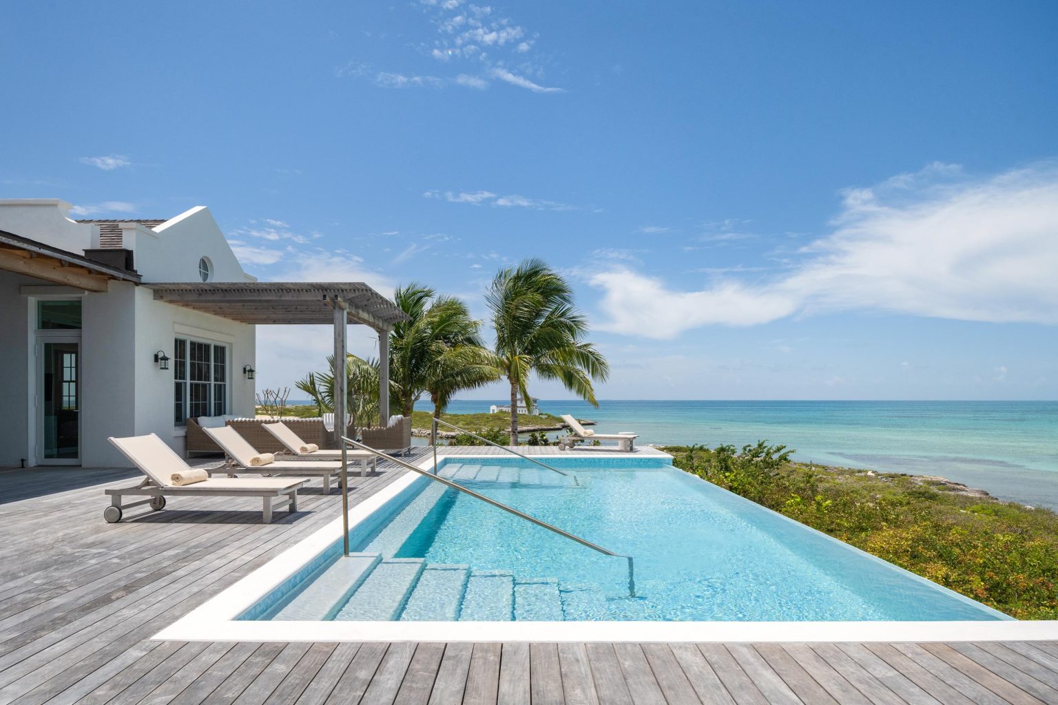 66a26e30b5f66acdcfa3cd54_10-ambergris-cay-puesta-del-sol-villa-pool-deck-3000px