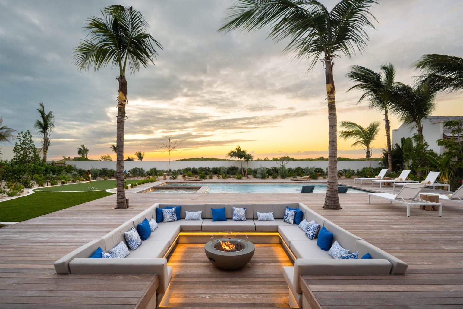 67805401feae154a16f24628_Ambergris-Cay-Dream-Estate-Away-Luxury-Villa-Pool-Deck-Firepit-Turks-and-Caicos-dusk