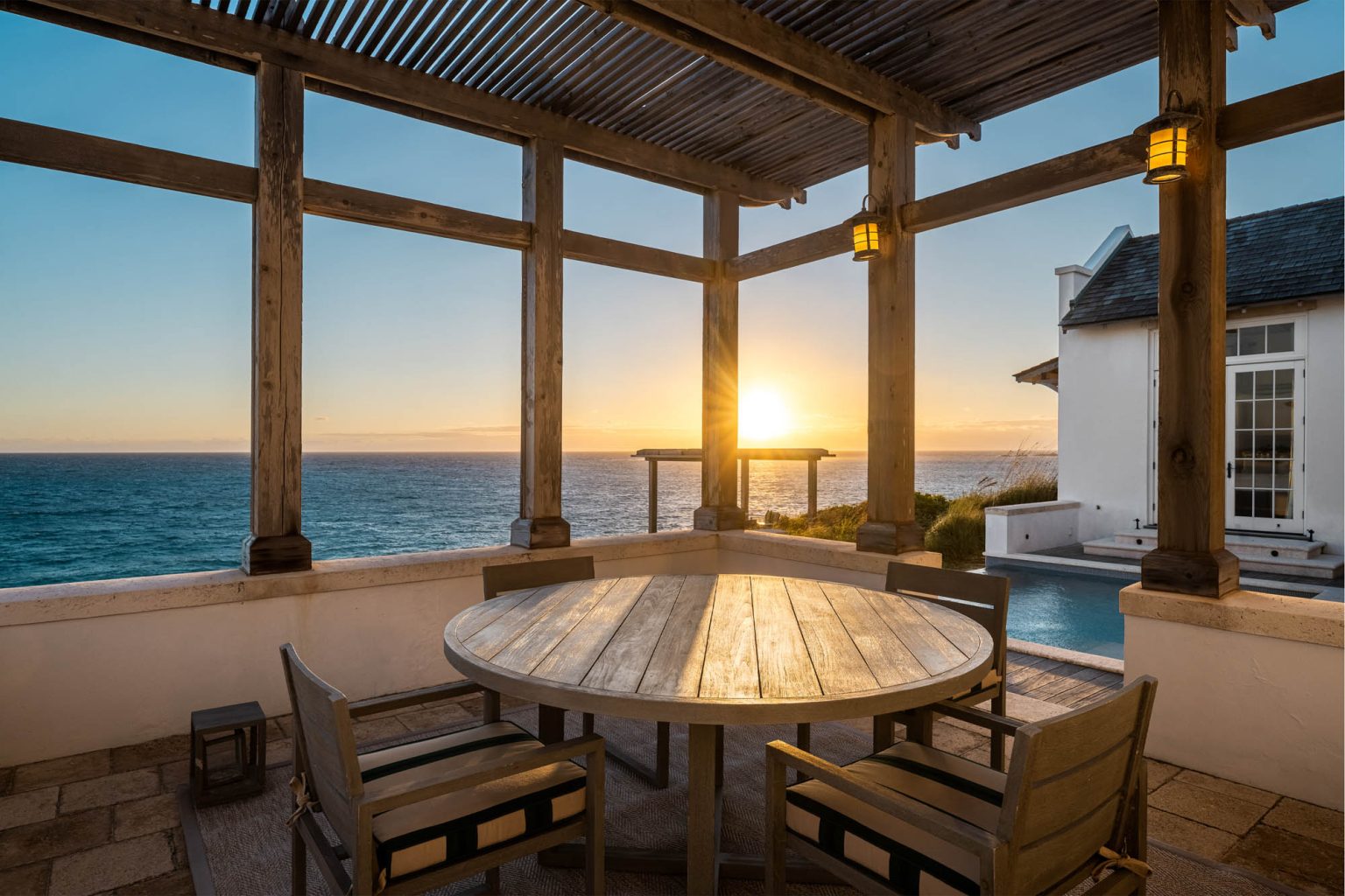 678ae2b001288084aae7f5a0_Ambergris-Cay-Osprey-4-bedroom-villa-outdoor-dining-area-at-sunrise