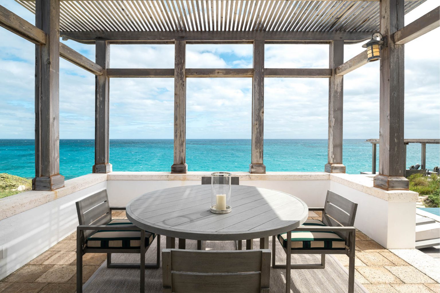 678ae2b0279023b86a8c14d4_Ambergris-Cay-Osprey-4-bedroom-villa-outdoor-dining-area-ocean-view-private-island-resort