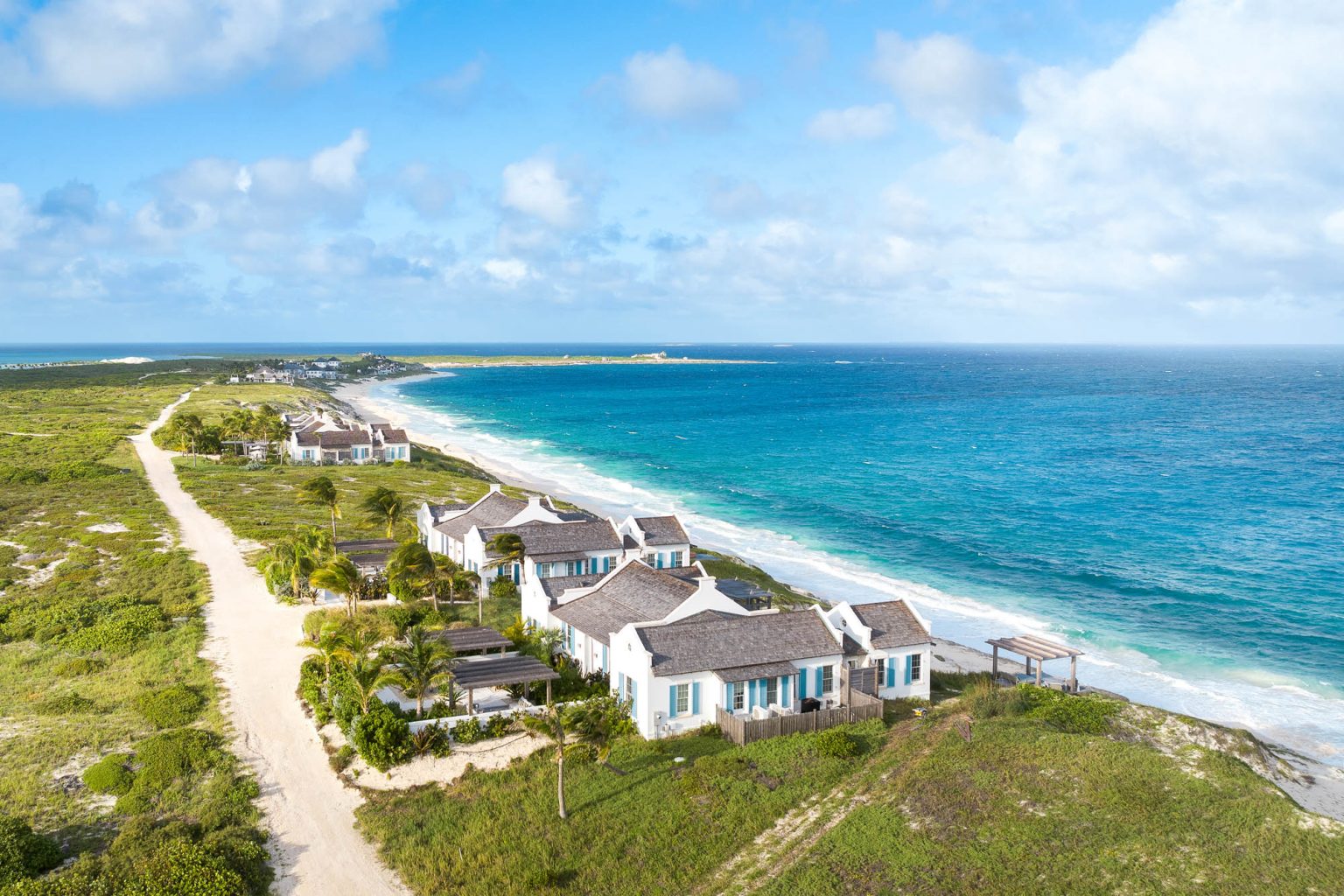 678ae2b0bd2c11fe19935e88_Ambergris-Cay-Osprey-4-bedroom-villa-Columbus-beach-aerial2-Turks-and-Caicos